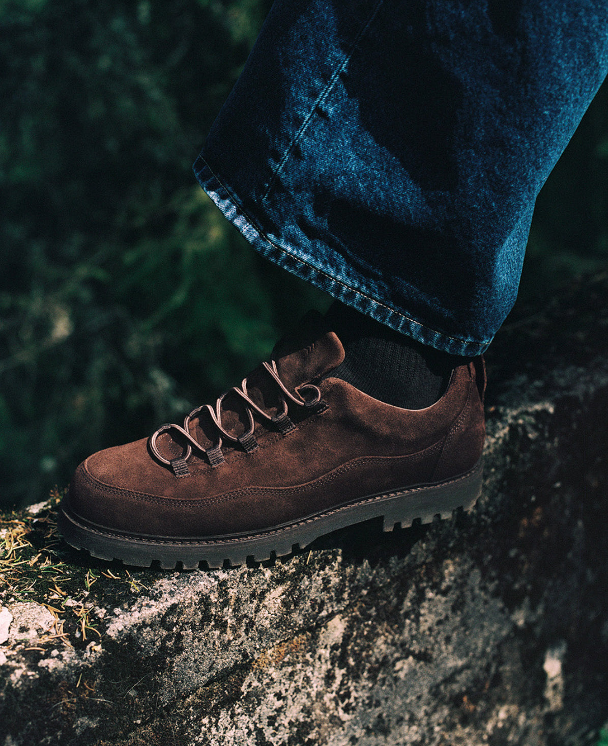 Brown New Movements shoe worn outdoors