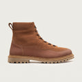 Brown suede boot with white fur lining on a light gray background